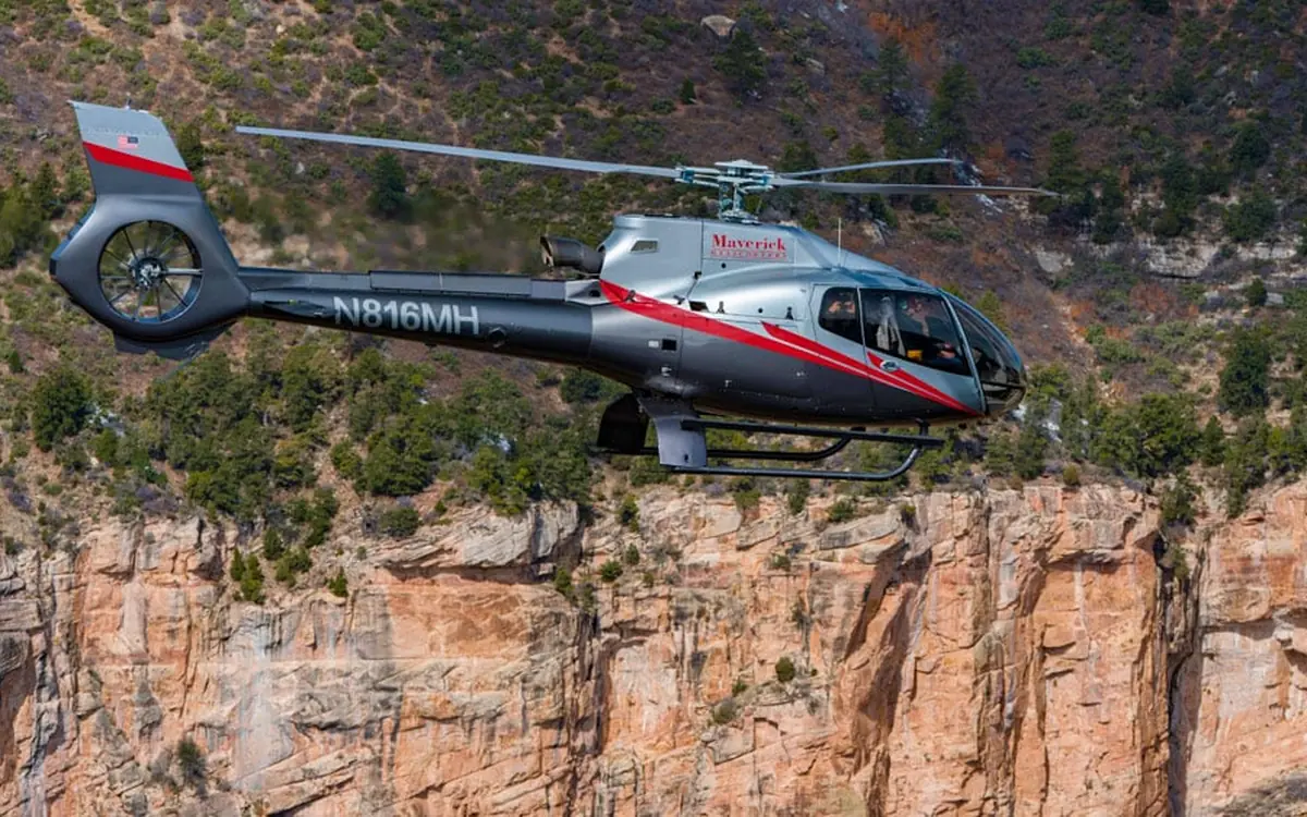 A helicopter flying over the Grand Canyon on a scenic route